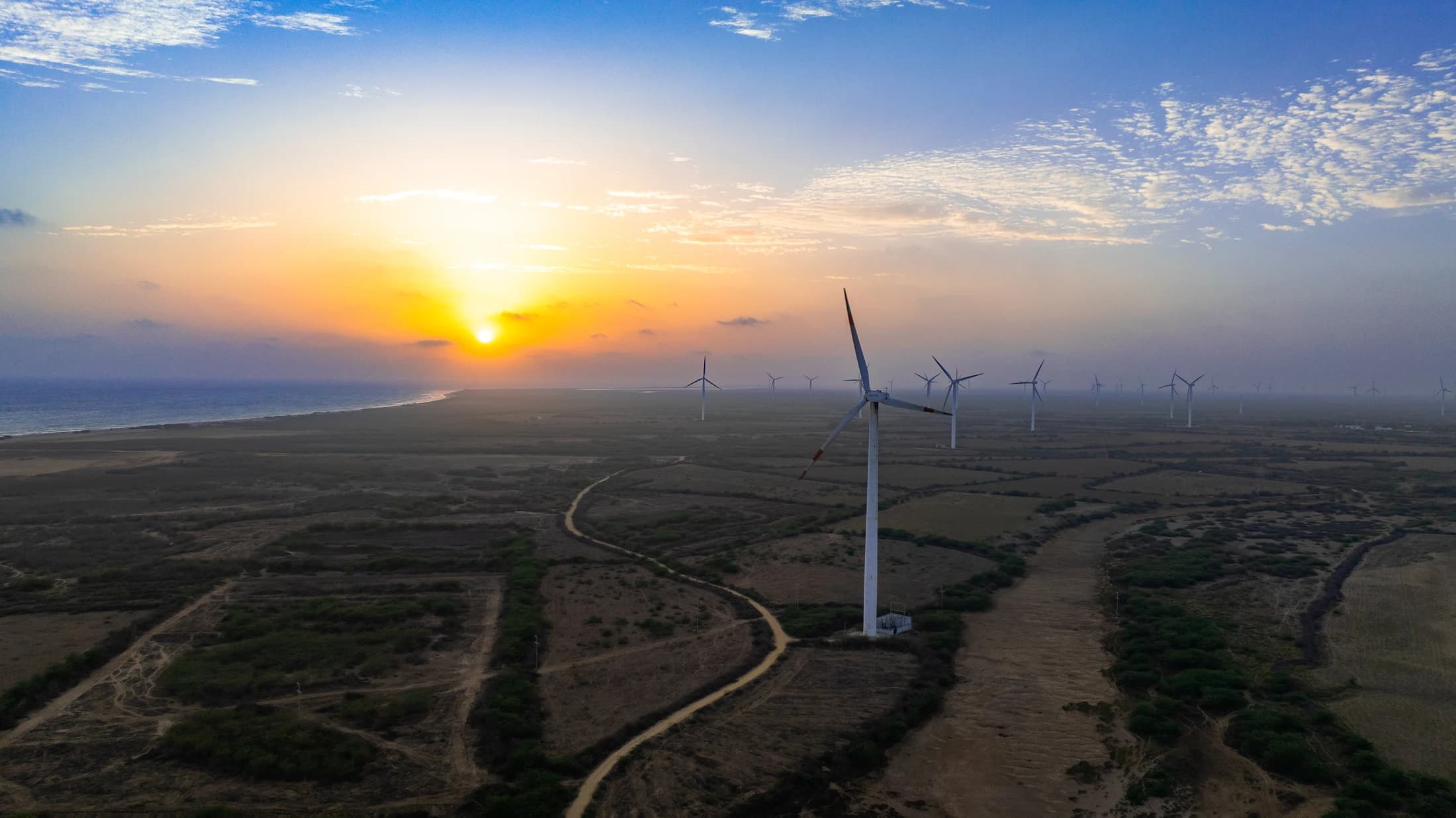 Kutch coastline at sunset with wind turbines and orange sky